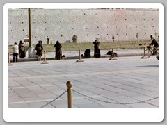 Pilgrims prostrating themselves in from of the palace