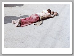 Pilgrims prostrating themselves in from of the palace