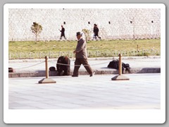 Pilgrims prostrating themselves in from of the palace